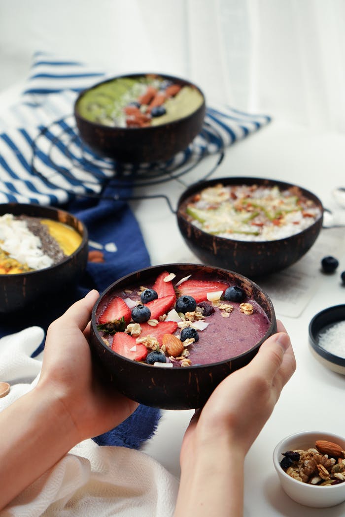 Colorful smoothie bowl with strawberries, blueberries, and almonds for a healthy breakfast.